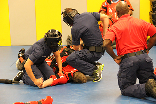 Maritime Enforcement Specialist A- School students practicing handcuffing during a dynamic evaluation at the Maritime Law Enforcement Academy in Charleston, South Carolina.