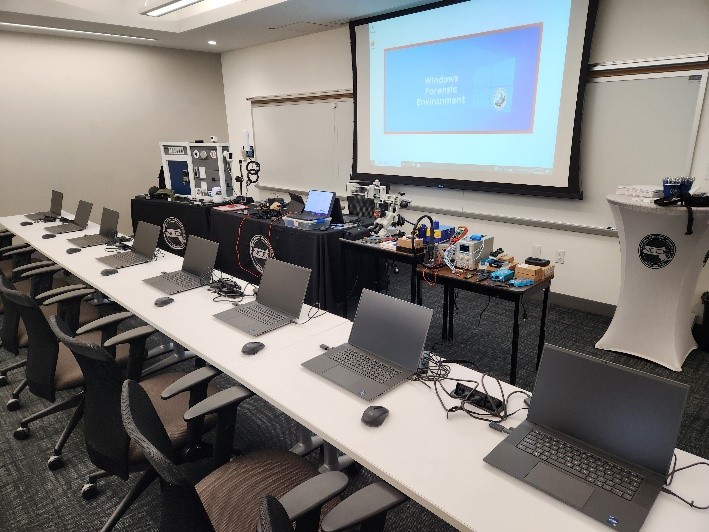   Federal Law Enforcement Training Centers classroom setup with Internet of Things (Iot) equipment and cellphone hardware data extraction equipment before class at the National Cyber Crime Conference (NCCC) in Norwood, Massachusetts from April 23-25, 2024. (FLETC CYD/John Riley)