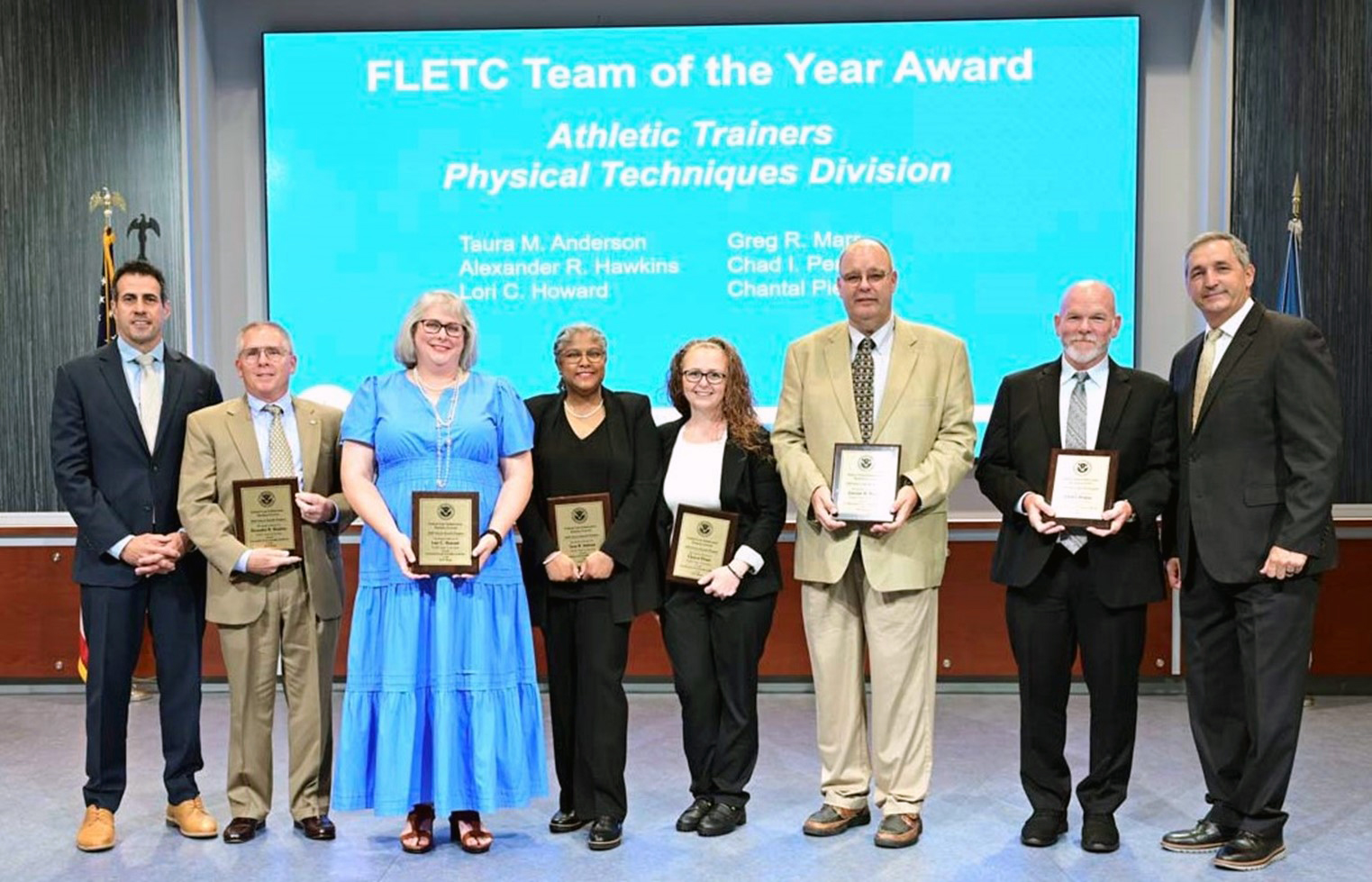 Federal Law Enforcement Training Centers (FLETC), 2023 Team of the Year Award awarded to Athletic Trainers from the Physical Techniques Division, Core Training Operations Directorate, presented by FLETC Director Benjamine C. Huffman and FLETC Deputy Director Kai J. Munshi at FLETC Annual Awards Ceremony, June 12, 2024, Glynco GA. (Photo by David Tucker, OPA)