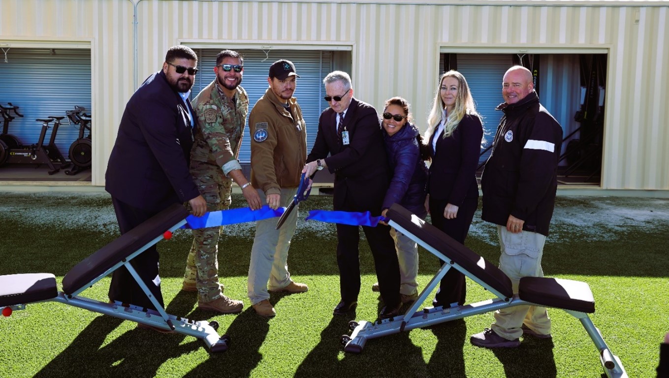 Left to Right. Brandon L.S. Mikkanen, Chief of Training, United States Indian Police Academy; Benjamin Avalos, Training Operations Supervisor, United States Border Patrol; Merrit Whitelow, Section Chief, Transportation Security Administration Training Center; Robert Price, Artesia Site Director, FLETC; Maria Beardsley, Sergeant-Technician, United States Secret Service; Liz Argo, Drivers/Firearms Division Chief, FLETC; Travis Beaty, Branch Chief Physical Techniques Advanced  Branch, FLETC; join together by cutting a ribbon to open the new outdoor gym at the FLETC-Artesia training delivery point, January 10, 2025.  (Photo/Trish Simpson, Supervisory Border Patrol Agent, Border Patrol Academy)