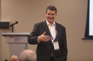 Executive Director Warwick Jones, Australian Institute of Police Management, engages an audience member on techniques that can be used to prepare law enforcement officers with good decision making skills during a crisis.